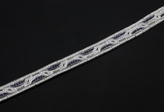 A stylish Art Deco style platinum, diamond and sapphire bracelet, 7.25in.